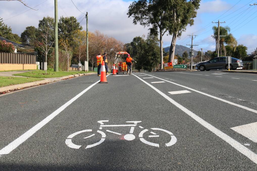 NEW LOOK: Workers mark out an expansive cycle lane along Pearce Street in Wodonga this week, but it hasn't been to everyone's liking, particularly nearby residents. 