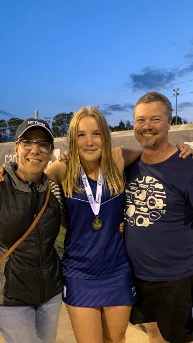 Ellie Jarratt, pictured with parents Mikaela and Tim, played a part in Victoria's under-15 girls victory at the national hockey championships at Narellan.