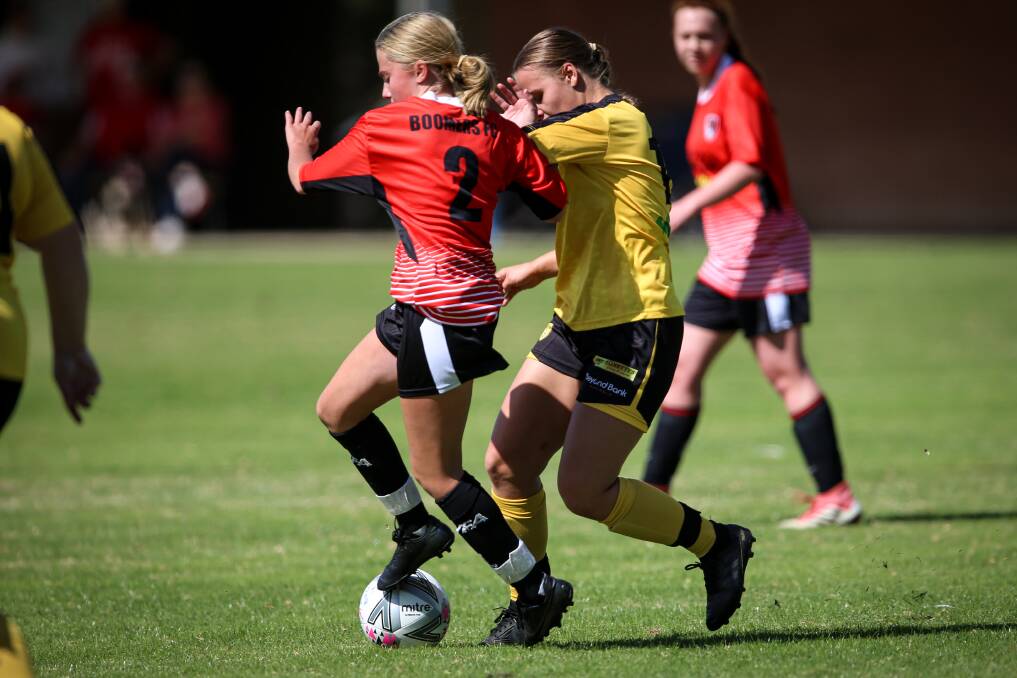 CLOSE CONTEST: Boomers' Savannah Abel and Albury Hotspurs' Ava Tuksar battle for the ball. Picture: JAMES WILTSHIRE