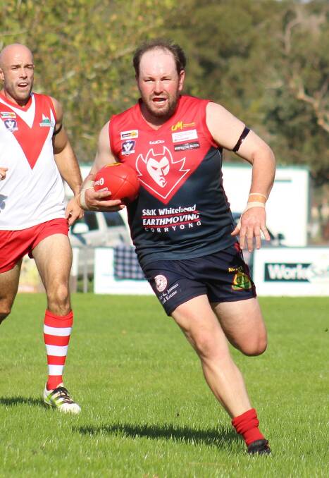 ON THE MOVE: Corryong coach Evan Nicholas finds some space as Federal co-coach Steve Fouracre gives chase. Fouracre faces a stint on the sidelines. Picture: DEB HARRAP
