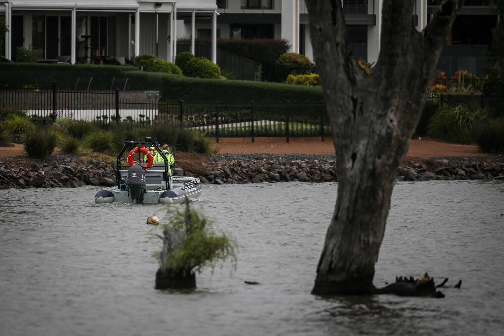 Police undertake a patrol near the shore of Lake Mulwala at Yarrawonga's Silverwoods Estate on Sunday in the search for a missing boy. Picture by James Wiltshire.
