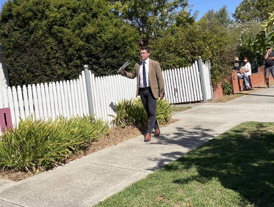 Stean Nicholls Real Estate auctioneer Lachlan Hutchins calls for offers for a four-bedroom home on Buckingham Street in North Albury on Saturday, March 23. Picture by Beau Greenway