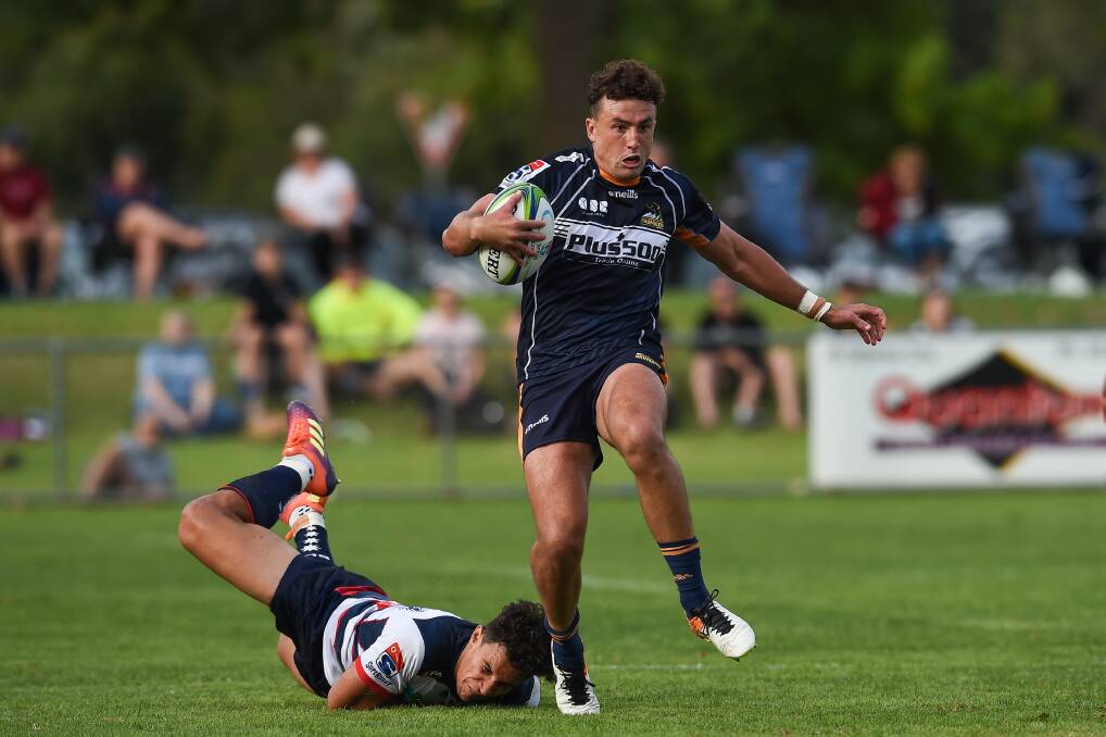 ON THE BURST: ACT Brumbies fullback Tom Banks leaves Melbourne Rebels' star Matt To'omua in his wake during Thursday night's Super Rugby trial at Greenfield Park. Pictures: MARK JESSER