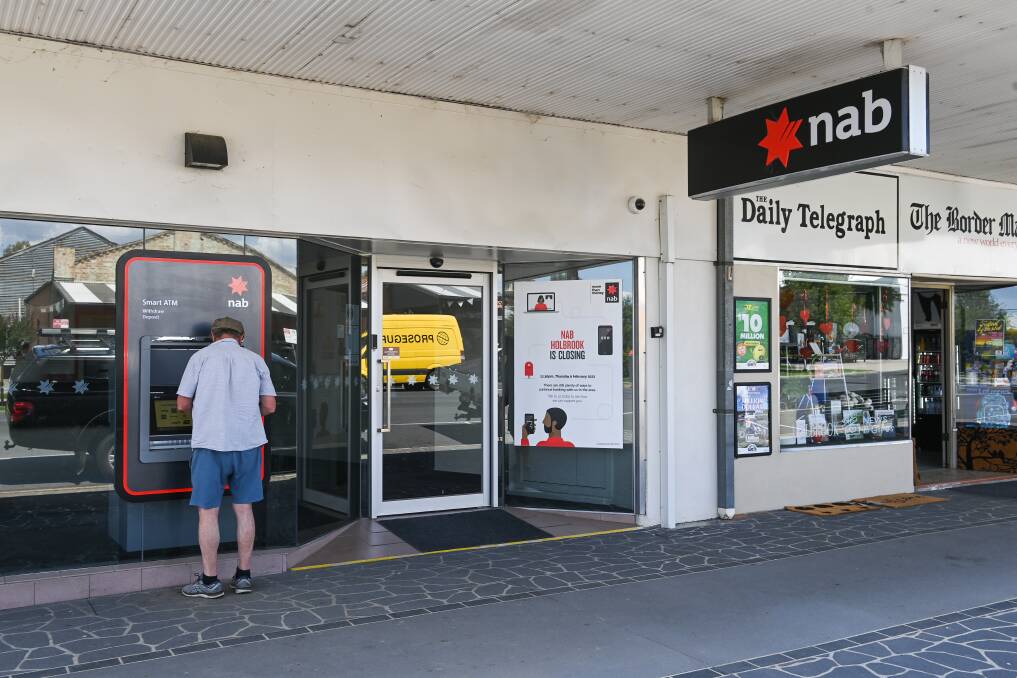 A Holbrook customer uses the ATM at the town's NAB branch days before its closure in February 2023. Picture by Mark Jesser