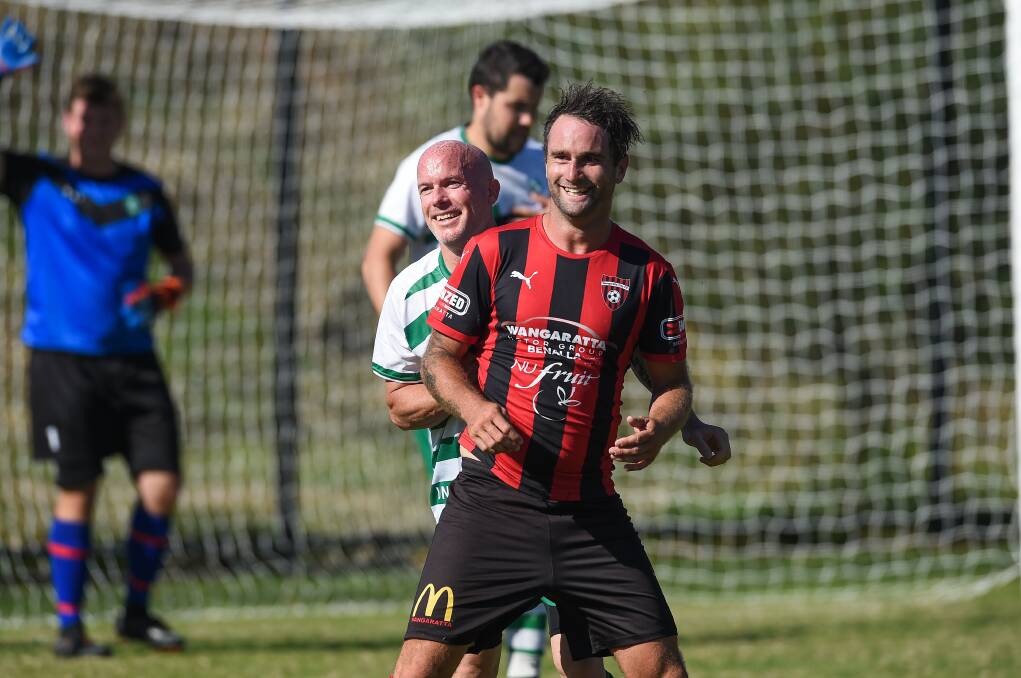 SHOCKED: Albury United's Kris Wheeler marks Wangaratta's Zac Walker during round one. The Greens defender had a heart attack on his way home from the game. Picture: MARK JESSER