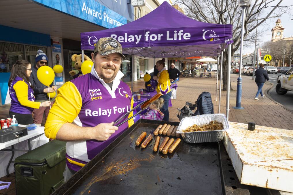 ON THE TOOLS: Matt Smilie cooking the barbecue at the Border Relay for Life launch event on Dean Street on Saturday. Picture: ASH SMITH