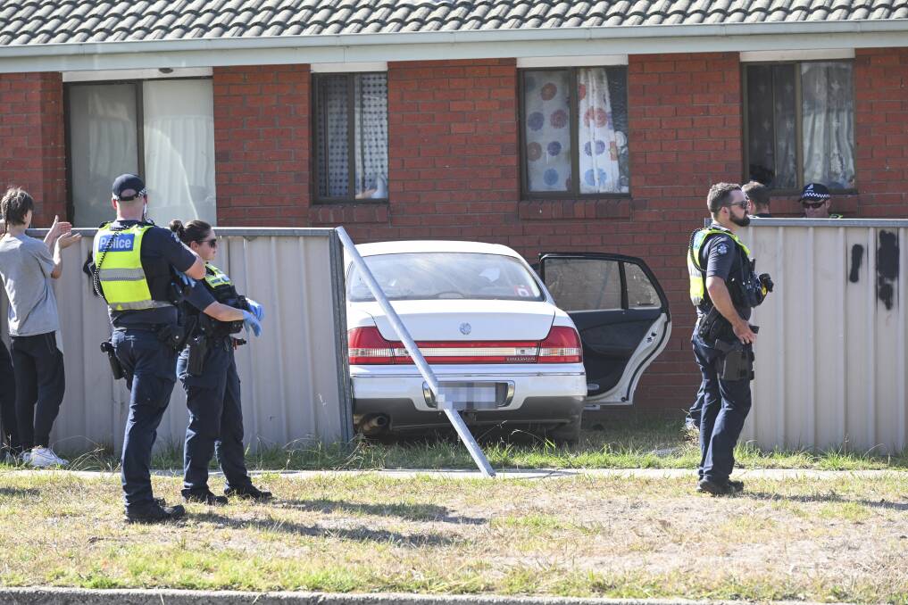 Police inspect the scene after a car crashed through a fence and into a house on Silva Drive in West Wodonga on Thursday, March 28. Picture by Mark Jesser