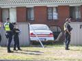 Police inspect the scene after a car crashed through a fence and into a house on Silva Drive in West Wodonga on Thursday, March 28. Picture by Mark Jesser