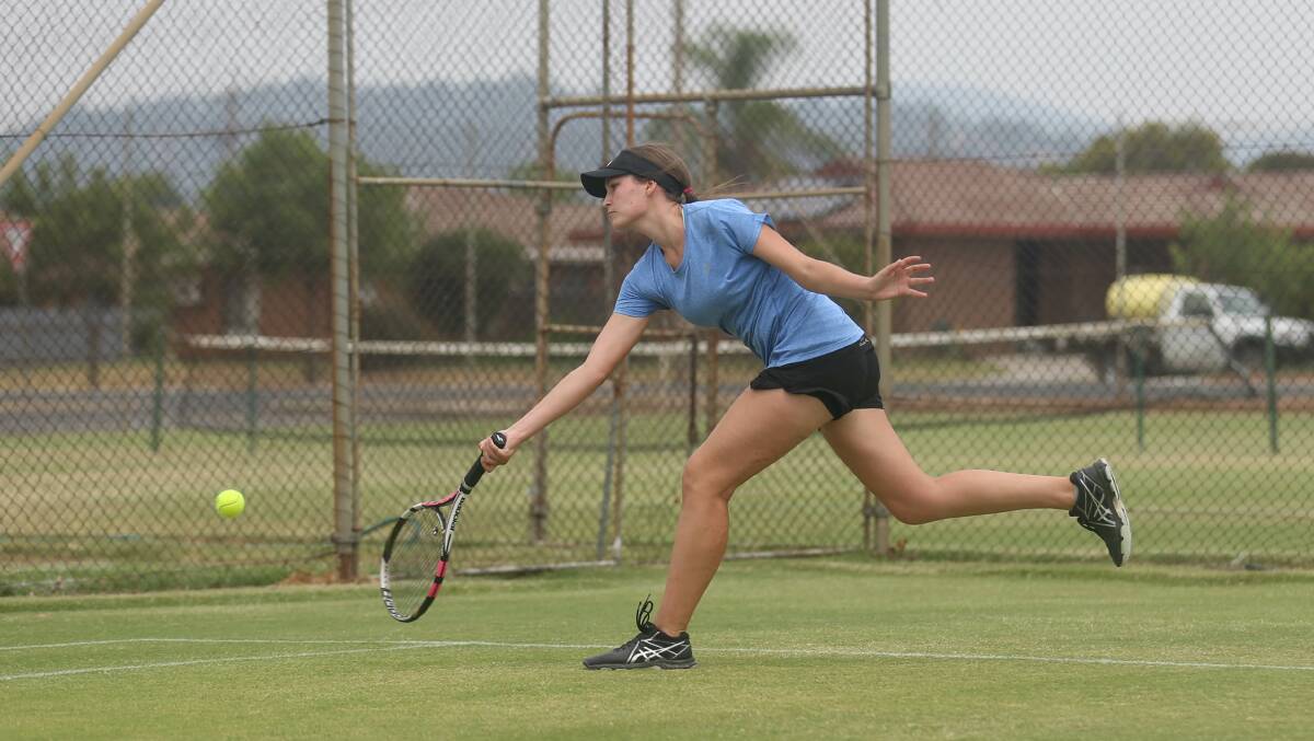 FULL STRETCH: Jessica Knoth was made to work for this return in her opening round singles match. Picture: TARA TREWHELLA