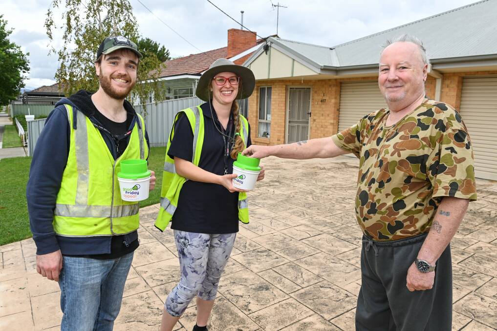 Volunteers Zachary Ryan and Lauren Sanders-Berg meet Frank Scott in Lavington as he makes another donation to the Good Friday Appeal. Picture by Mark Jesser