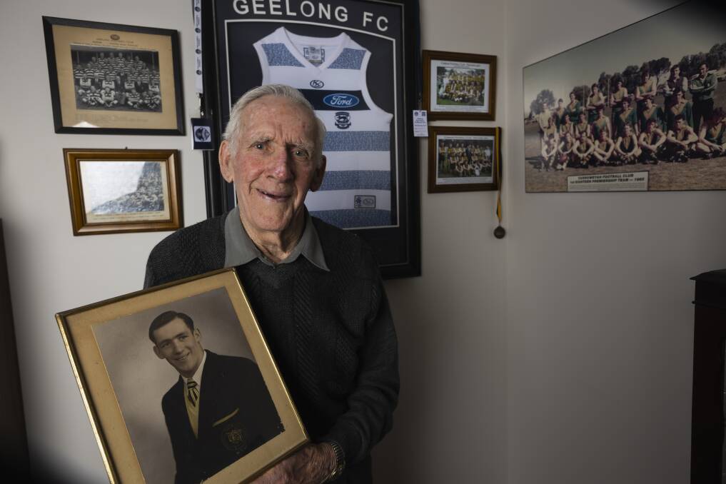 Colin Barton with a photo from his playing days at Albury before he was recruited by Geelong. Picture by Ash Smith