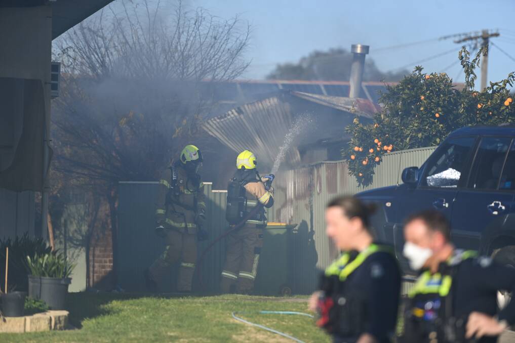 QUICK RESPONSE: Fire Rescue Victoria crews extinguish a house fire on Ballard Street in Wodonga on Tuesday. Picture: MARK JESSER