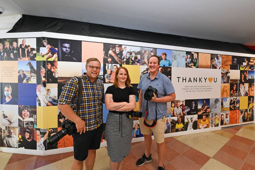 BEHIND THE LENS: Border Mail photographers Mark Jesser, Tara Trewhella and James Wiltshire alongside their work used in a thank you collage at Albury's Myer Centrepoint.
