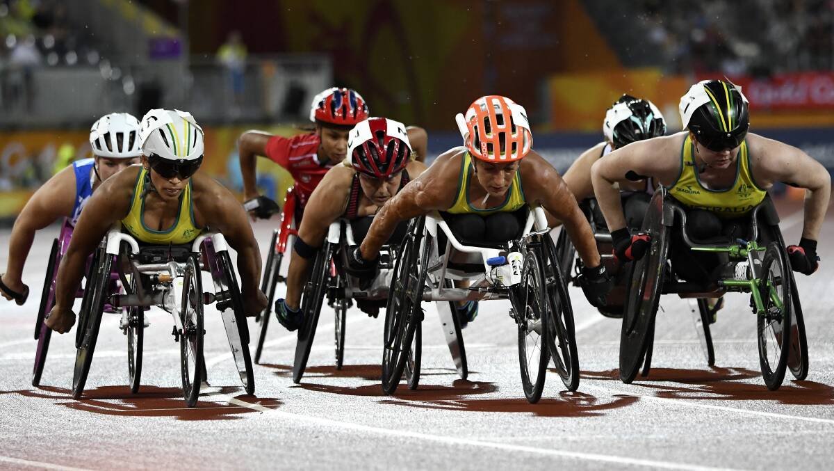 DETERMINED: Madison de Rozario, Eliza Ault-Connell and Angela Ballard of Australia in action during the Women's T54 1500m final at the Commonwealth Games. Picture: AAP