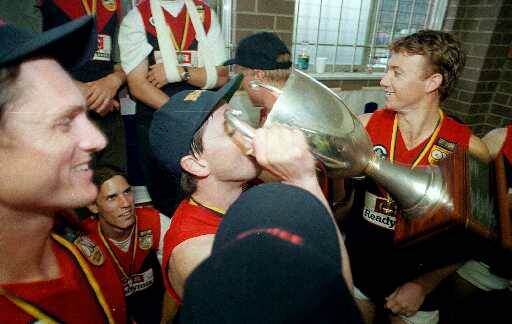 HISTORY MAKING: Darren Harris drinks from the 1998 premiership cup after coaching Wodonga Raiders to its first and only Ovens and Murray flag.