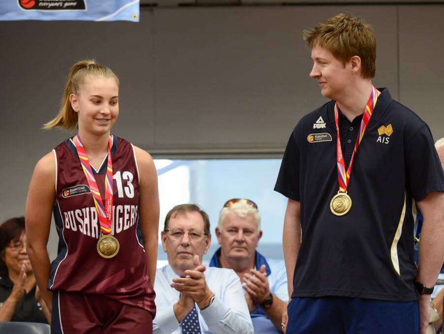 SUPER COACH: Jazmin Shelley and Shannon Seebohm display their World Championship gold medals at the Australian Country Junior Basketball Cup.