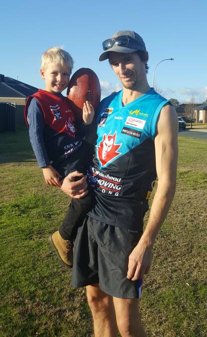 Corryong's Peter Jeffries shows off the club's special jumper with his son, Rylan.