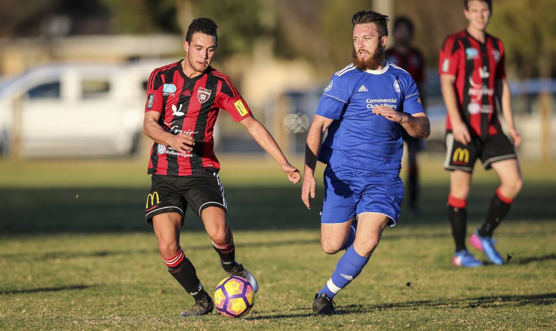 ONE TO WATCH: Albury City's David Samiec hunts down Mason Hope during the side's recent clash with Wangaratta. Picture: MARK JESSER