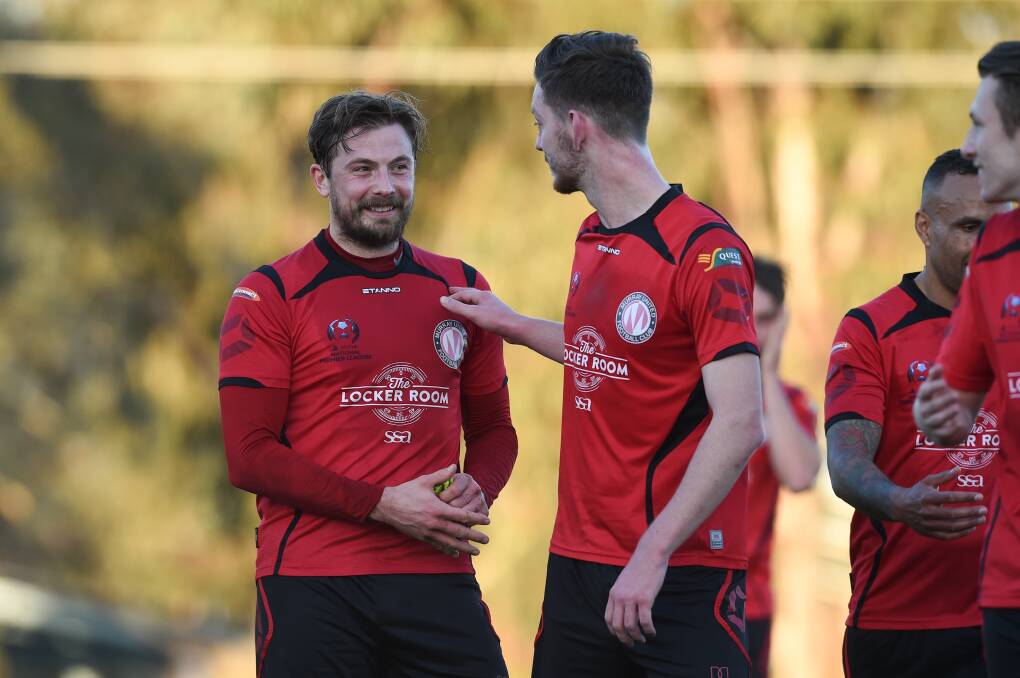 Murray United skipper Ashley Dunn celebrates the side's win over Dandenong City with Alex West. Picture: MARK JESSER