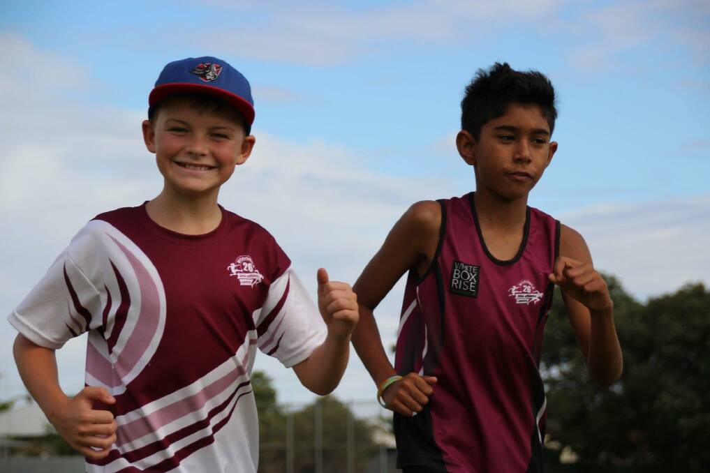 THUMBS UP: Wodonga little athletes Jasper Summerfield and Curby Caroopen are very excited to hit the ground running with new equipment for the club this season.