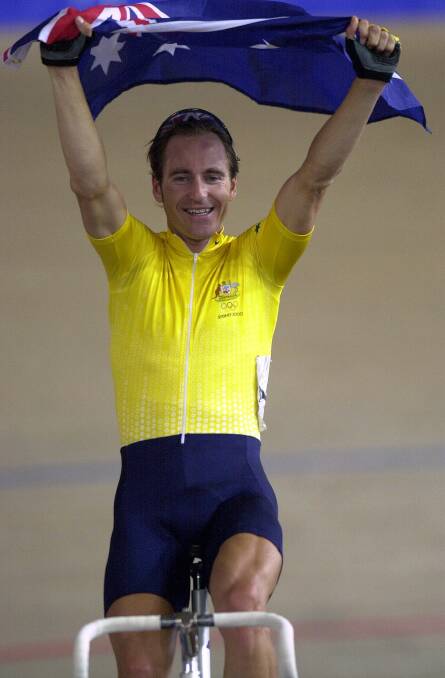 SPECIAL: Walwa-born track cyclist Scott McGrory completes a victory lap with the Australian flag after capturing gold with Brett Aitken in the madison.