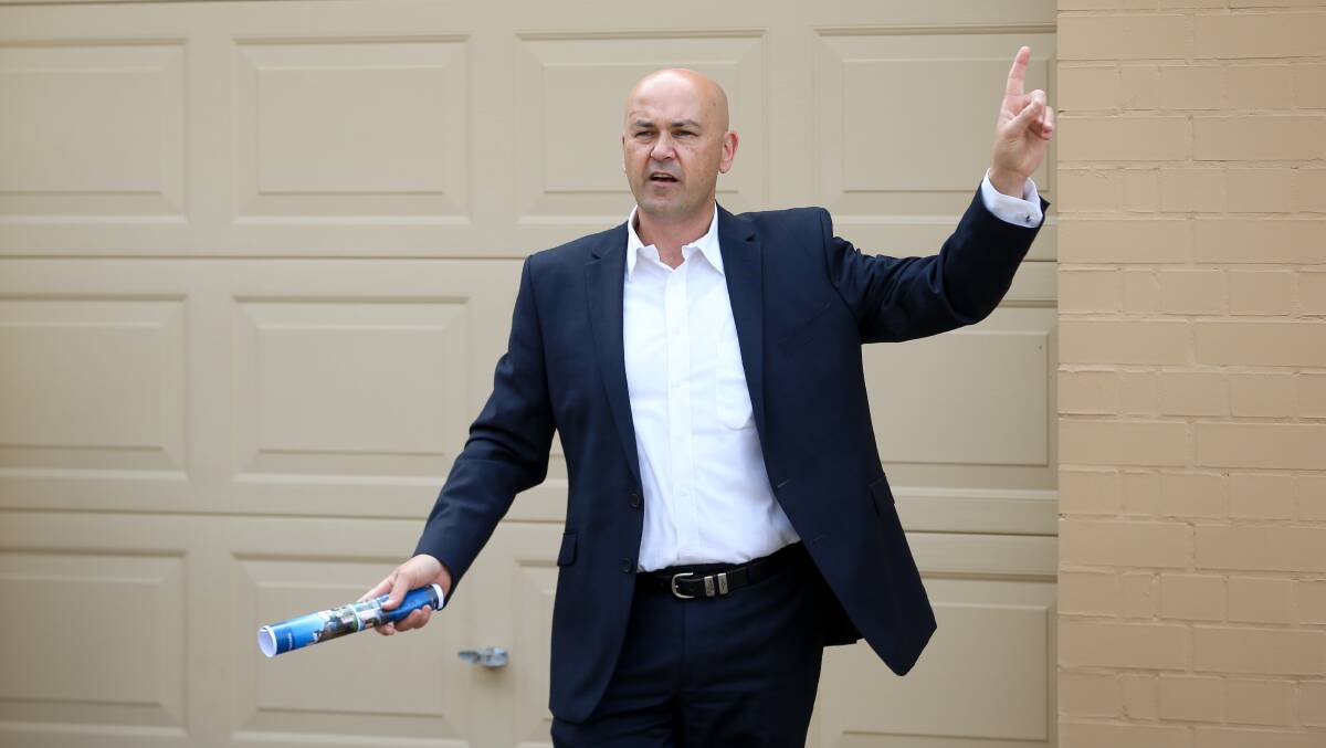 PLACE YOUR BIDS: Bonnici and Associates First National agent and auctioneer William Bonnici calls for offers for railway porters cottages in Albury on Saturday.