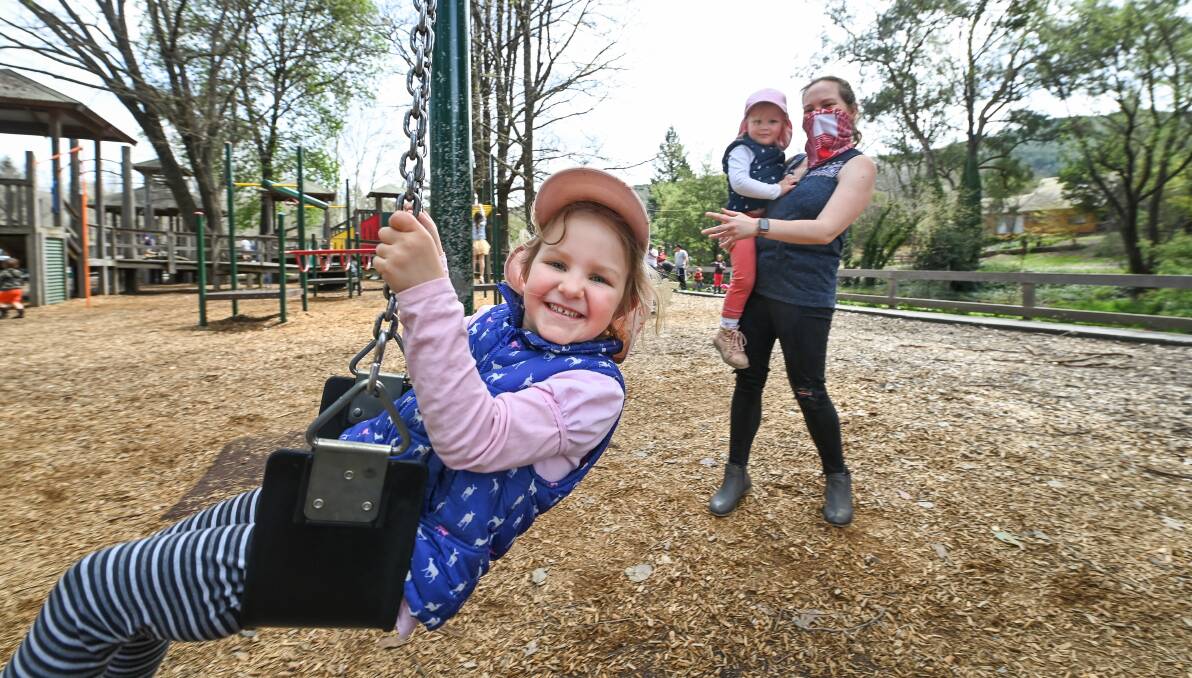 FUN IN THE SUN: Falls Creek mother Stephanie Sellar-Peam with daughters, Norah, 4, and Clara, 3, at Bright's Centenary Park on Saturday. Picture: MARK JESSER