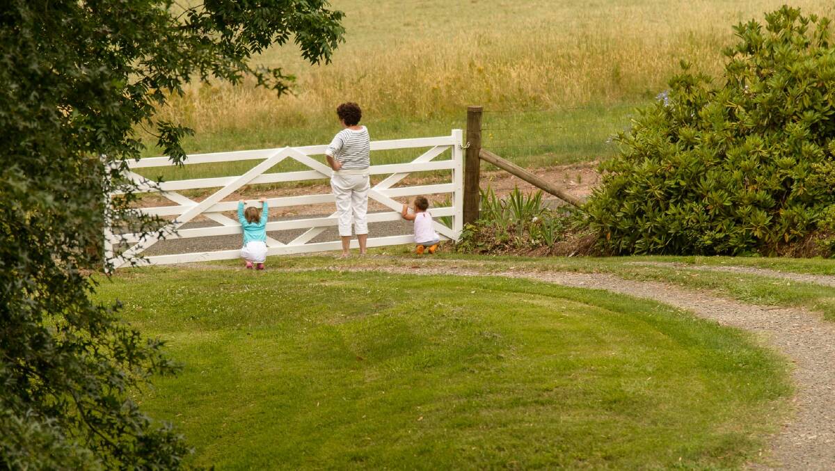 Kate Evans' mum overlooks their Mount Beauty property with her grandchildren. Picture: MATTHEW REX
