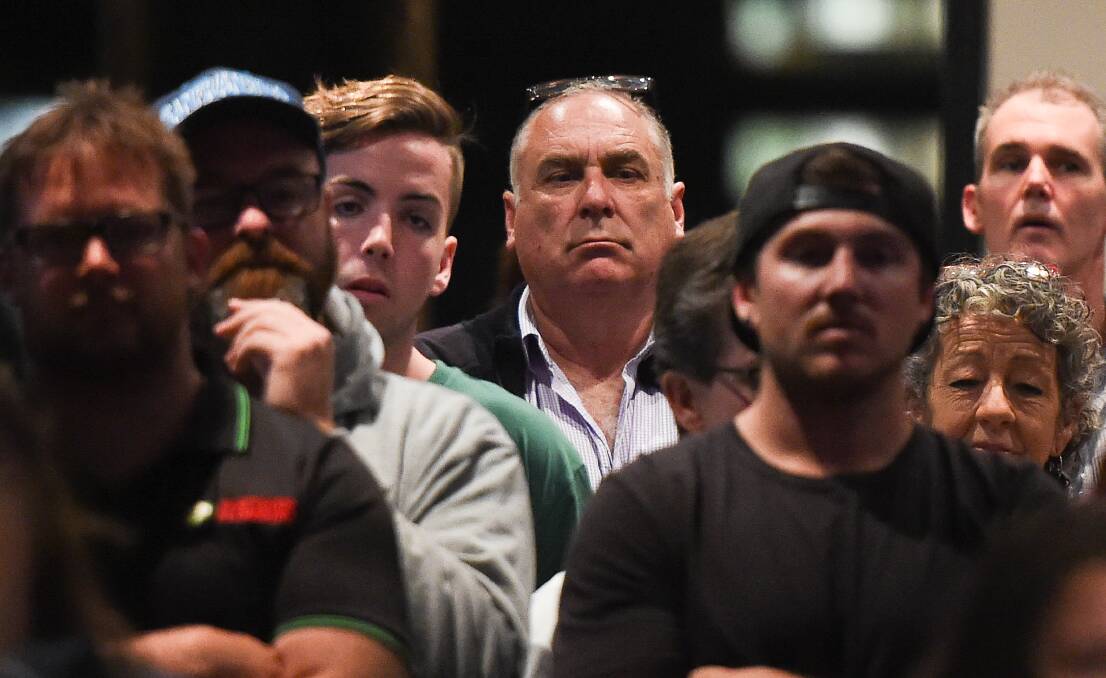 Interested onlooker: Albury councillor Murray King, with glasses resting on his head, watches proceedings at last week's public meeting over pool fees for public aquatic centres. Picture: MARK JESSER
