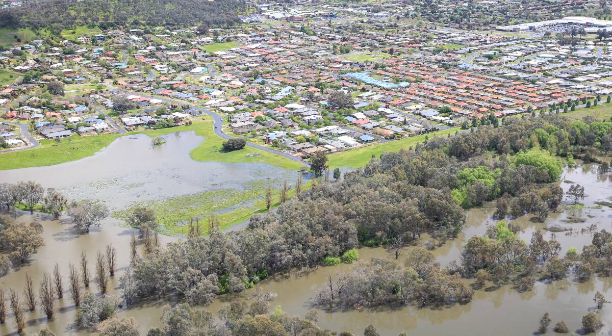 BIG WET: Floodwaters edge perilously close to homes in East Albury as captured from a Helifly chopper on Monday. The Murray River was expected to reach between 5.30 and 5.35 metres on Monday night. Pictures: JAMES WILTSHIRE 