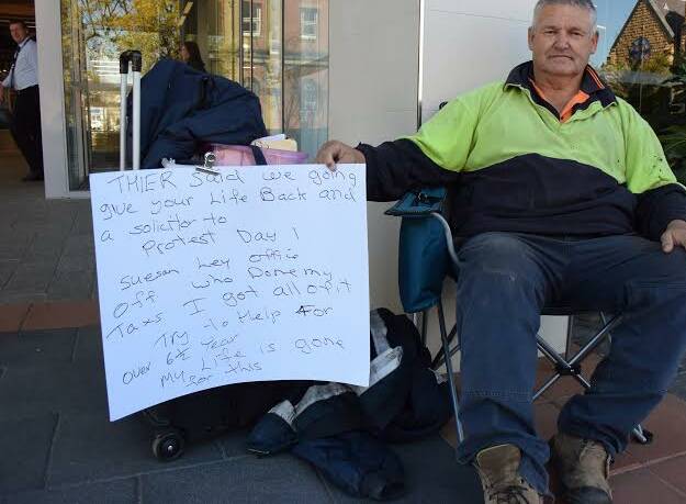 Lone protester: Ricky Hicks outside the Albury tax office. He is objecting to his treatment by the institution in relation to his returns. 