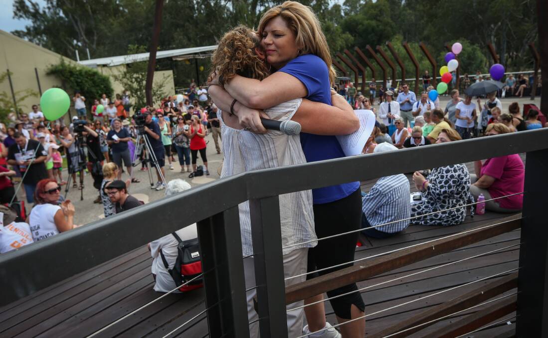BONDED BY TRAGEDY: Tania Maxwell and Carol Roadknight embrace at an anti-violence rally in Wangaratta earlier this year as part of the Enough is Enough campaign. 