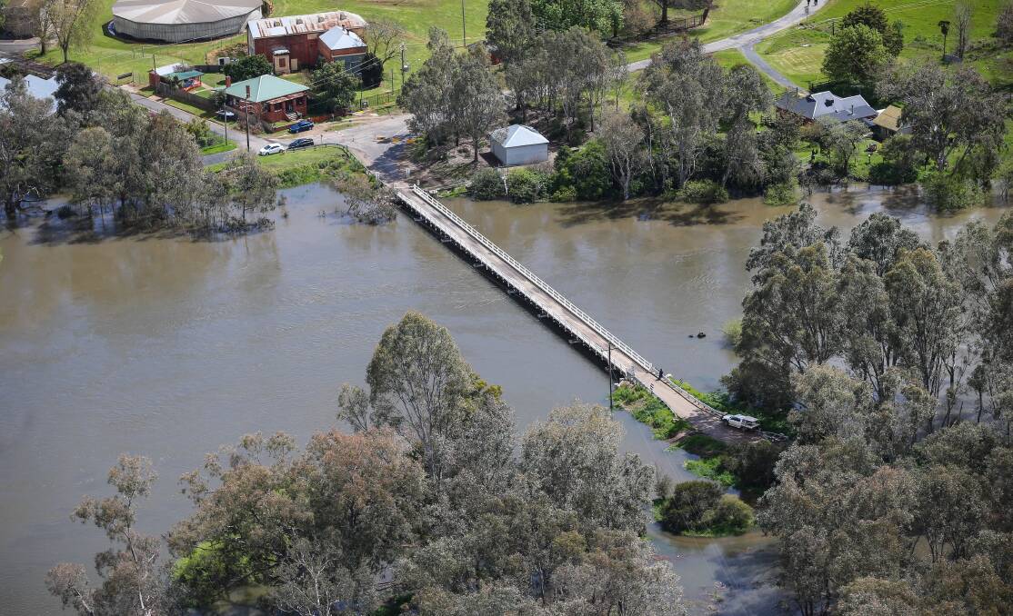 BRIDGE OVER TROUBLED WATER: The Boundary Road bridge crossing to Island Road on Bonegilla Island holds strong against a fast flow from the surging Murray River.