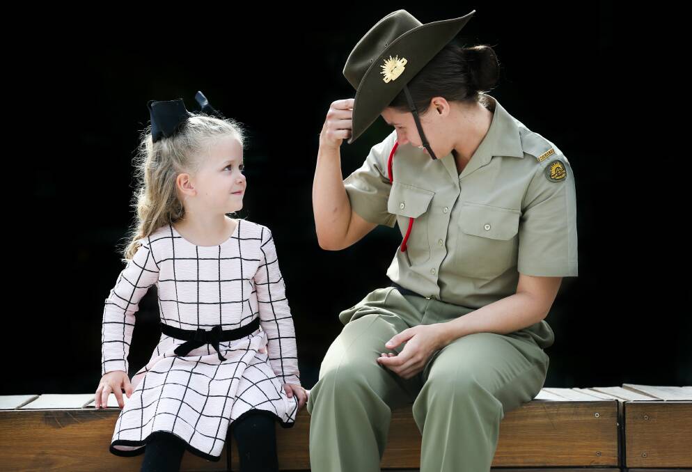 Voilet Pfeiffer, 3, from Wodonga, was eager to learn about Anzac Day from Private Penny Worland of Bandiana School of Ordnance.