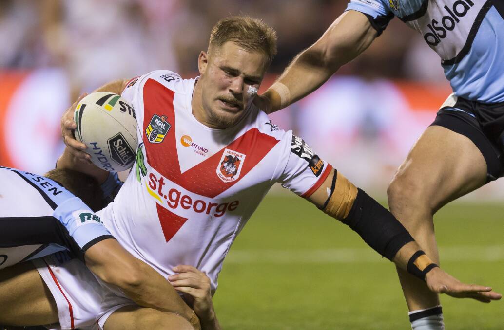 Breathing fire: Jack de Belin of the Dragons is tackled during the Round 6 NRL match the Sharks at WIN Stadium in Wollongong on Friday. Picture: AAP