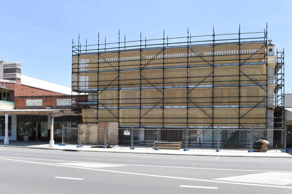 UNDER WRAPS: Scaffolding has been put up around the former Australia Cafe building on Albury Street in Holbrook. Preliminary work is happening and demolition should take place in 2020. There was a push by the community to try to protect the facade.