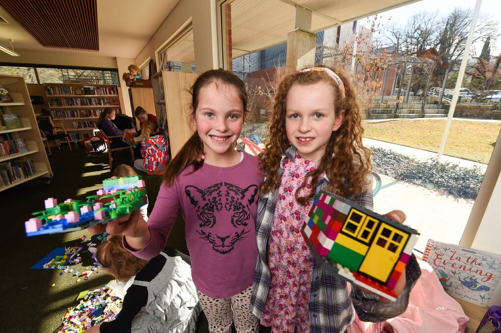 BRICK BRAINSTORMING: Holly Lerch, 7, and Aliya McCormack, 8, took part in the LEGO Mania session at Yackandandah. Picture: MARK JESSER