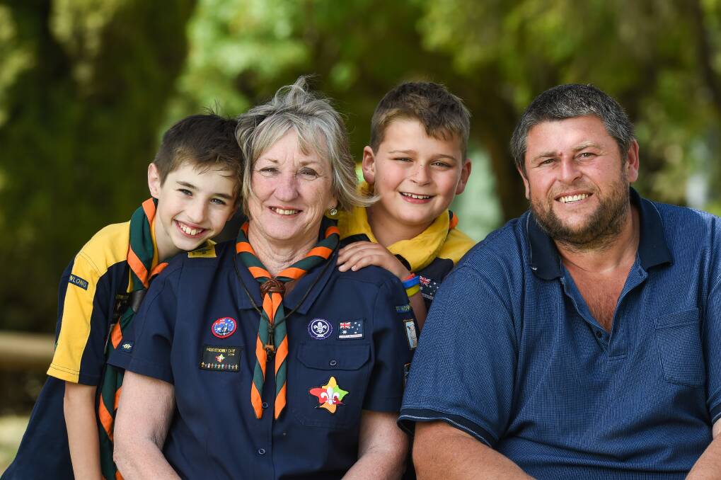 FAMILY FEEL: Sheryl Pitman has mentored many youngsters like Flynn Keeble, 9, and Jake Gardiner 9, in her 45 years leading the Howlong Scouts. She's also officiated marriages of members, like Jake's dad, Greg. Picture: MARK JESSER
