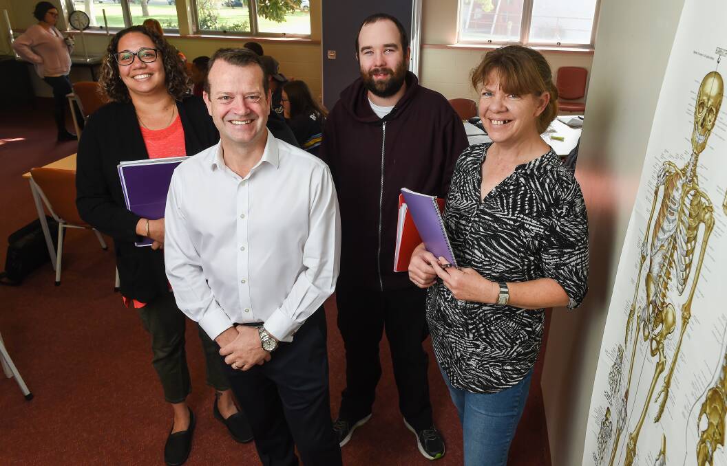 MORE TO COME: Wodonga TAFE chief executive Mark Dixon with community services students Katrice May, Lachlan Davidson and Nicola Bremner. Picture: MARK JESSER