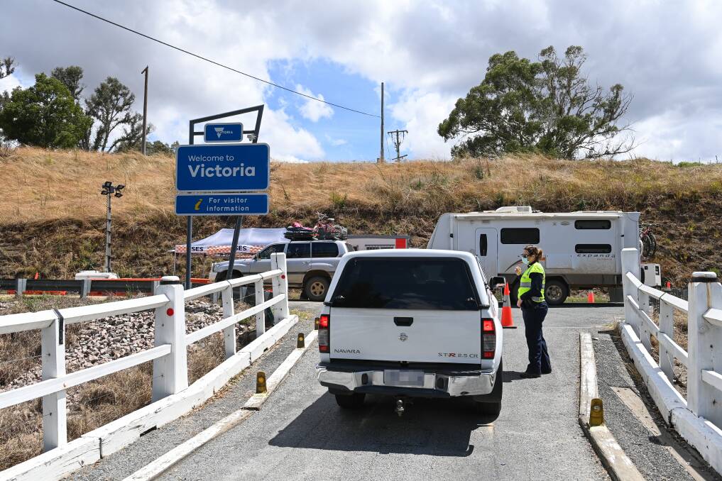 STOPPED: The Towong Road bridge crossing is being staffed after being shut with blockades during the NSW closure. But those with exemptions can't enter Victoria there. Picture: MARK JESSER