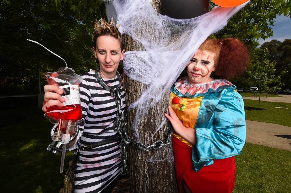 IN THE SPIRIT: Wodonga TAFE Community Services co-ordinator Cathy Prior and student Chloe Lade were among those dressing up for the Halloween-themed event. Picture: MARK JESSER