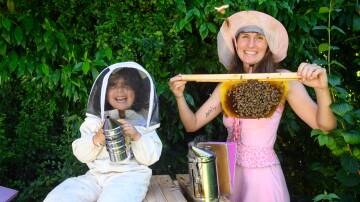 JOY: Eskdale's Emily Mikschi operates the Kenyan Top Bar Hive with her daughter, Olive Caparra, 3. 