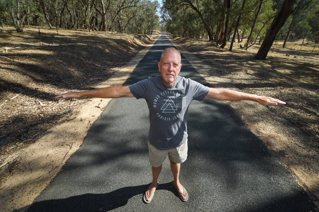DANGEROUS: Woomargama resident Paul Rowe demonstrates the narrowness of the Tunnel Road, which B-Doubles have been granted access to use for timber haulage. Mr Rowe believes even with planned upgrades, it will not be safe. Picture: MARK JESSER