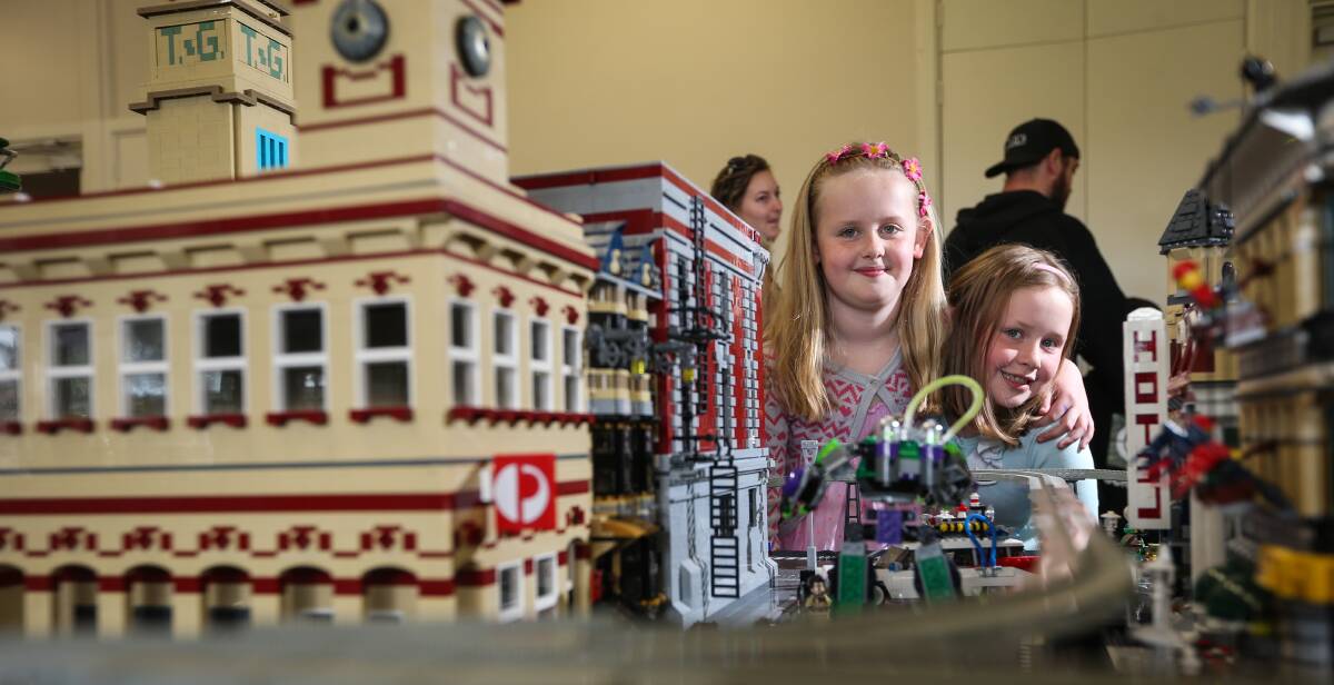WOWED: Chelsea Winckle, 9, and Lily Winckle, 6, visited the AWLUG collection with their dad, Rhys. They were excited to see the Albury post office, new to the display.