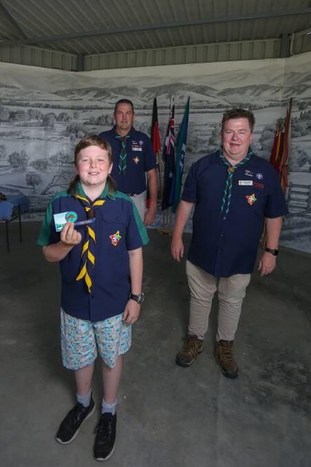 SUCCESS: Teddy Byatt, 11, was invested into the Corryong Scouts by district commissioner Ian Hall and Darren Leckie. Picture: TARA TREWHELLA
