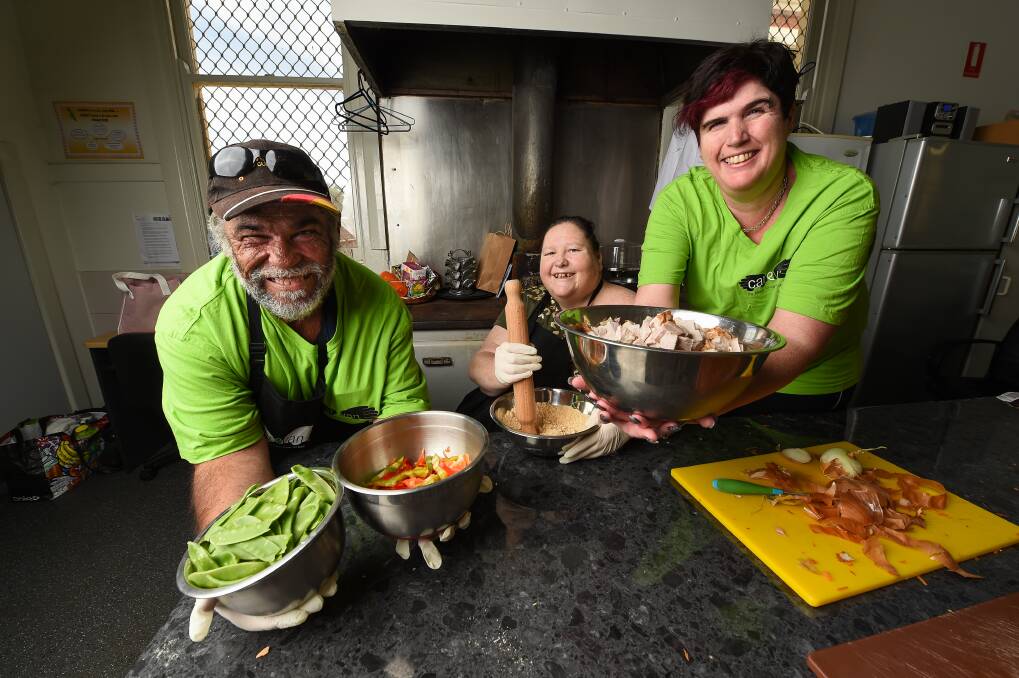 COOK UP: Mercy Connect program participants Daniel Quinn, Susan Healy and Emily Nagle cook meals for Carevan in Mercy Connect's Bottlebrush Cafe at Thurgoona. Picture: MARK JESSER