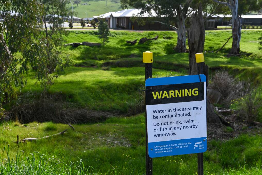 Signs were erected near an unnamed creek in Killara after a sewerage spill. Picture: MARK JESSER