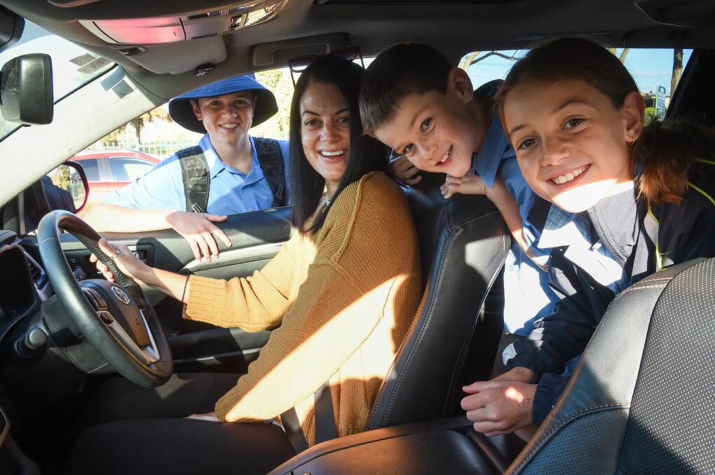 WAIT AND SEE: Wodonga mum Bec Cohen drops off Wodonga Catholic College grade 7 student Chase, 12, before heading to St Monica's with Quinn, 10 and Arhi, 7. Both schools, like all Victorian schools, are starting school holidays three days early. Picture: MARK JESSER