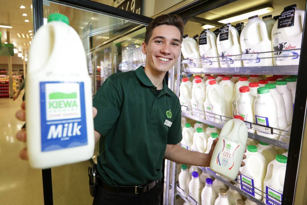  IT'S BACK: Woolworths Wodonga South staffer Ashley Benfield stocks the recently-returned Kiewa Milk, now back in all major supermarkets. Picture: JAMES WILTSHIRE