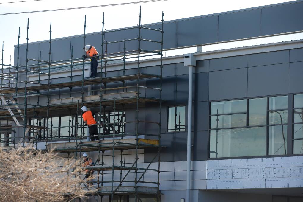 UNDERWAY: Contractors are on site at the Wodonga Senior Secondary College, where non-compliant cladding is being removed. The school is one of 13 in Victoria where cladding is being removed. Picture: MARK JESSER
